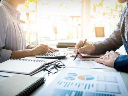 business man financial inspector and secretary making report, calculating or checking balance. Internal Revenue Service inspector checking document. Audit concept