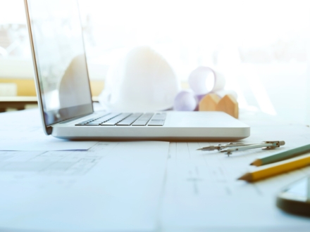 Construction and Repair work. Drawings for building Architectural project, blueprint rolls and divider compass on table. Engineering tools concept. Copyspace of Architecture and Engineer Desktop.